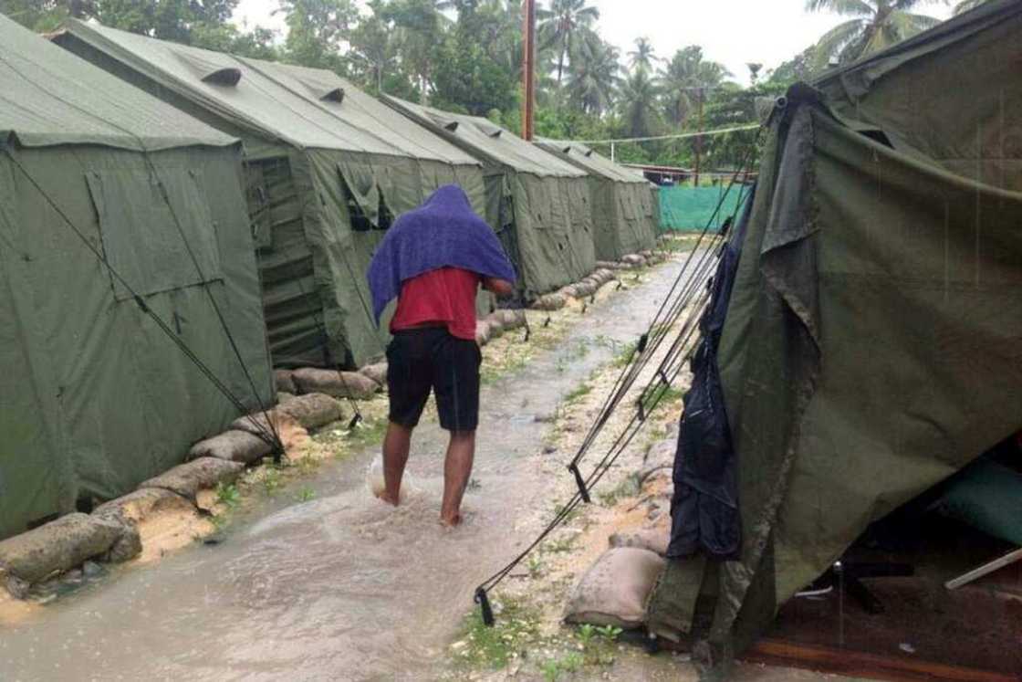 An undated photo obtained from the Refugee Action Coalition in 2014 shows a man walking through an Australian processing centre on Manus Island