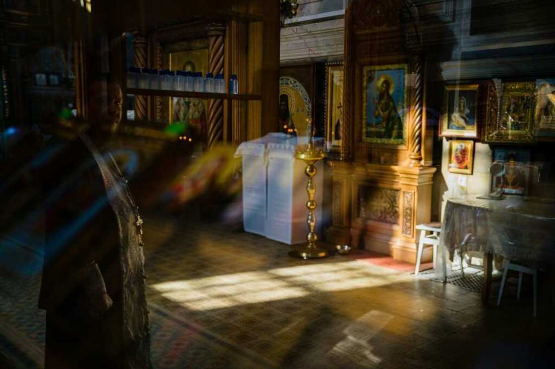 Orthodox priest Semyon reflected in a window in a church Izyum after its recapture Orthodox priest Semyon reflected in a window in a church Izyum after its recapture