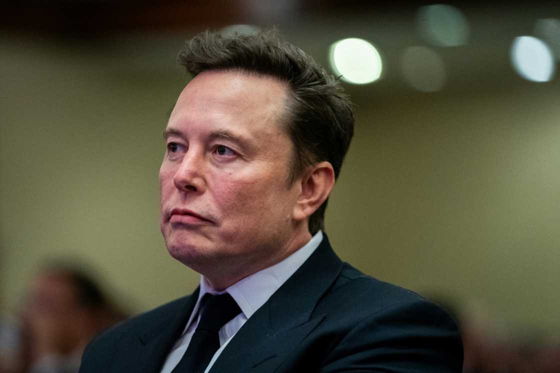 Elon Musk listens as US President-elect Donald Trump speaks during a meeting with House Republicans Elon Musk listens as US President-elect Donald Trump speaks during a meeting with House Republicans