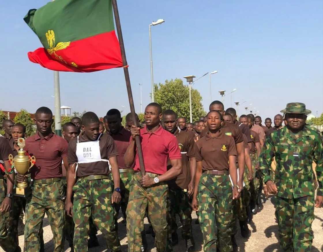 NDA cadets walking as they hoist a flag