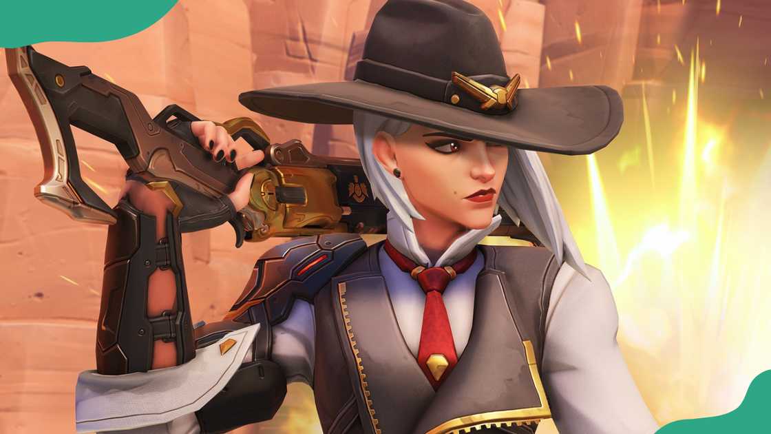 Ashe stands in a desert setting with stone structures. Ashe stands in a desert setting with stone structures.