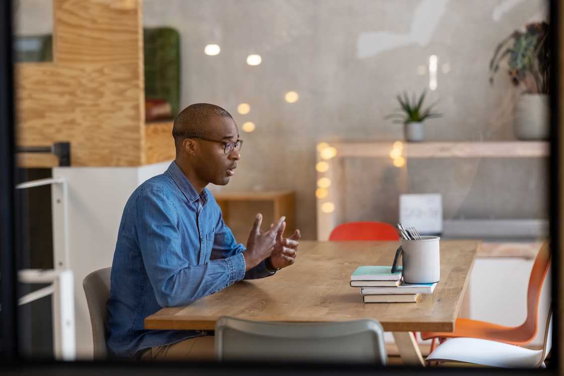 A male entrepreneur talking to a client in office A male entrepreneur talking to a client in office