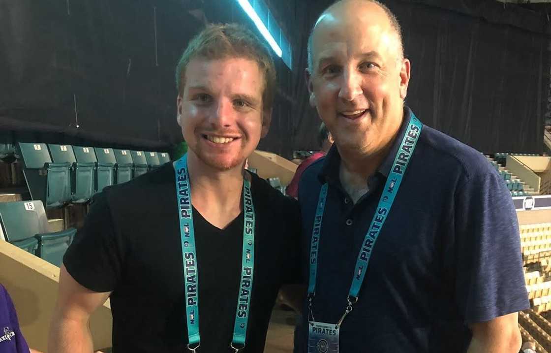 Tony Massarotti (R) and a friend smile as they pose for a picture
