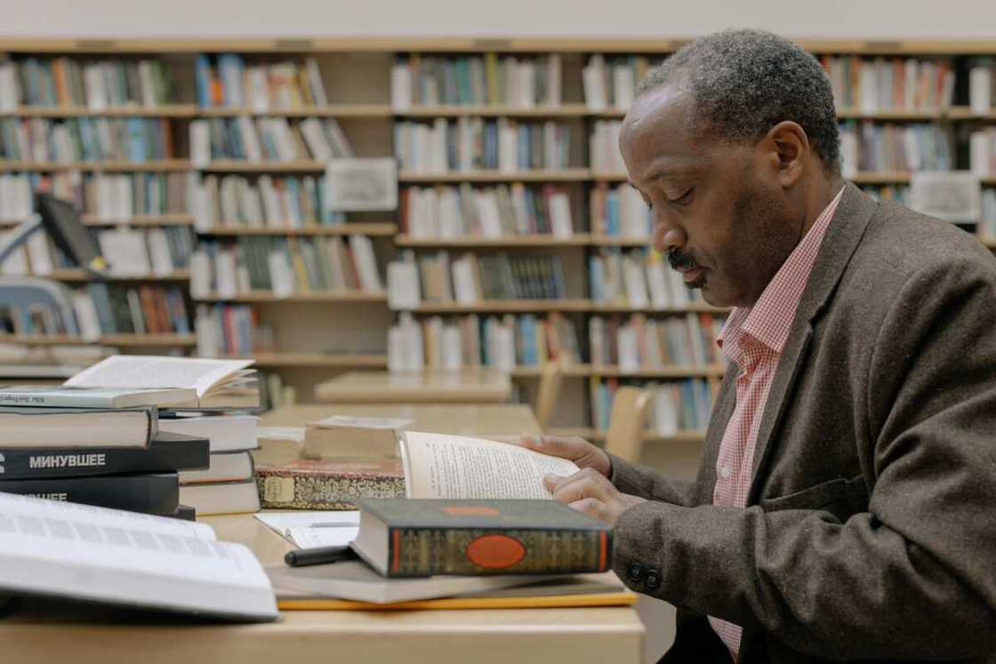 A man reading a book in the library