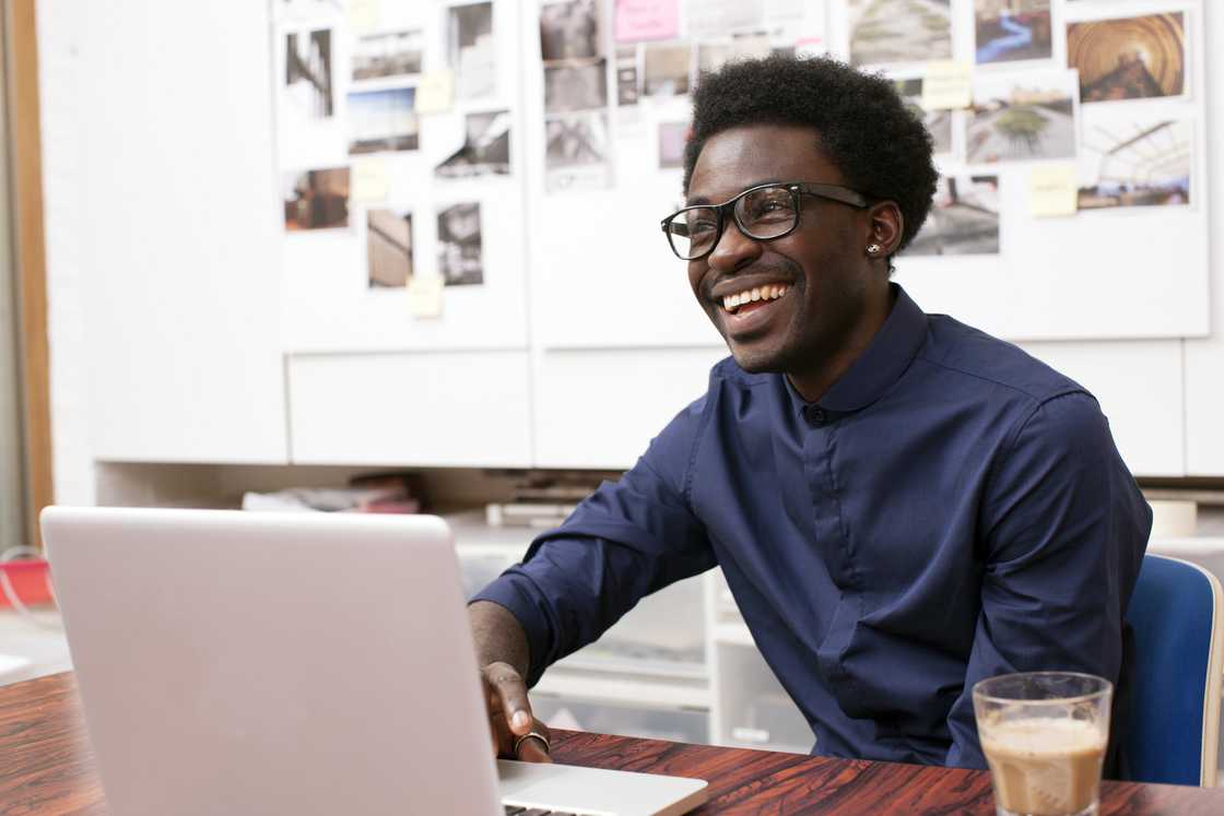 A young man working at his desk. A young man working at his desk.