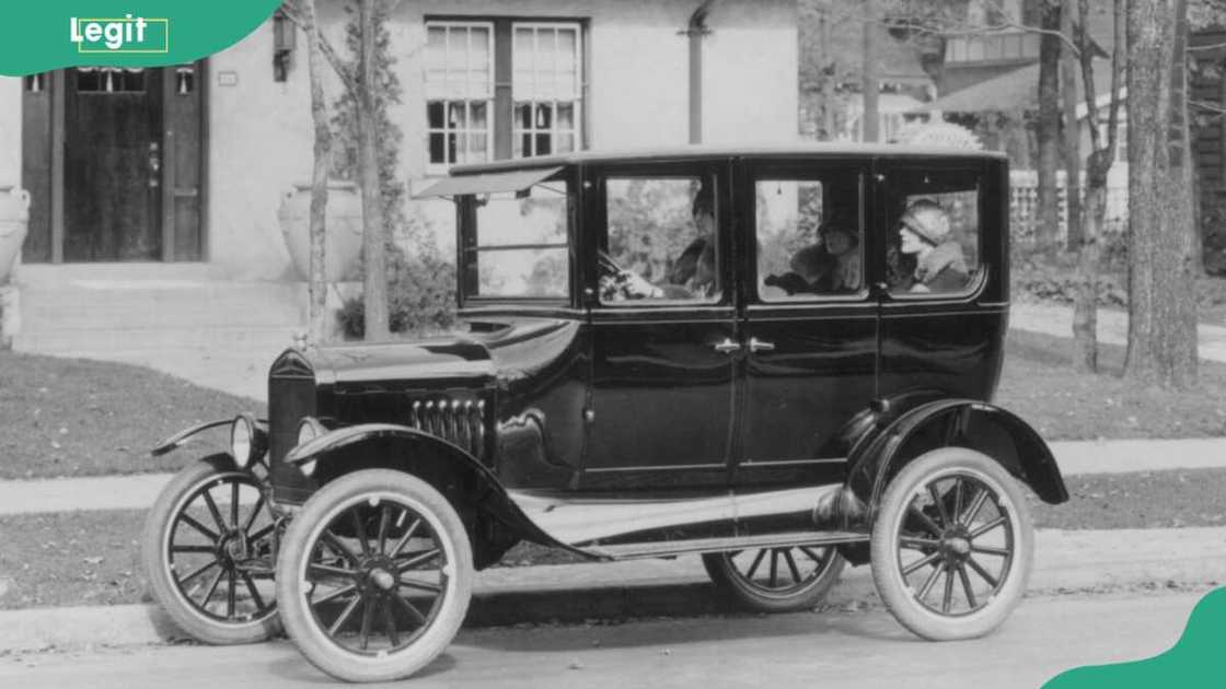 A model 'T' Ford motor-car outside a suburban house A model 'T' Ford motor-car outside a suburban house