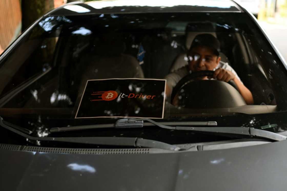 Taxi driver Napoleon Osorio keeps a sign in his car to let customers know that he accepts payments in bitcoin