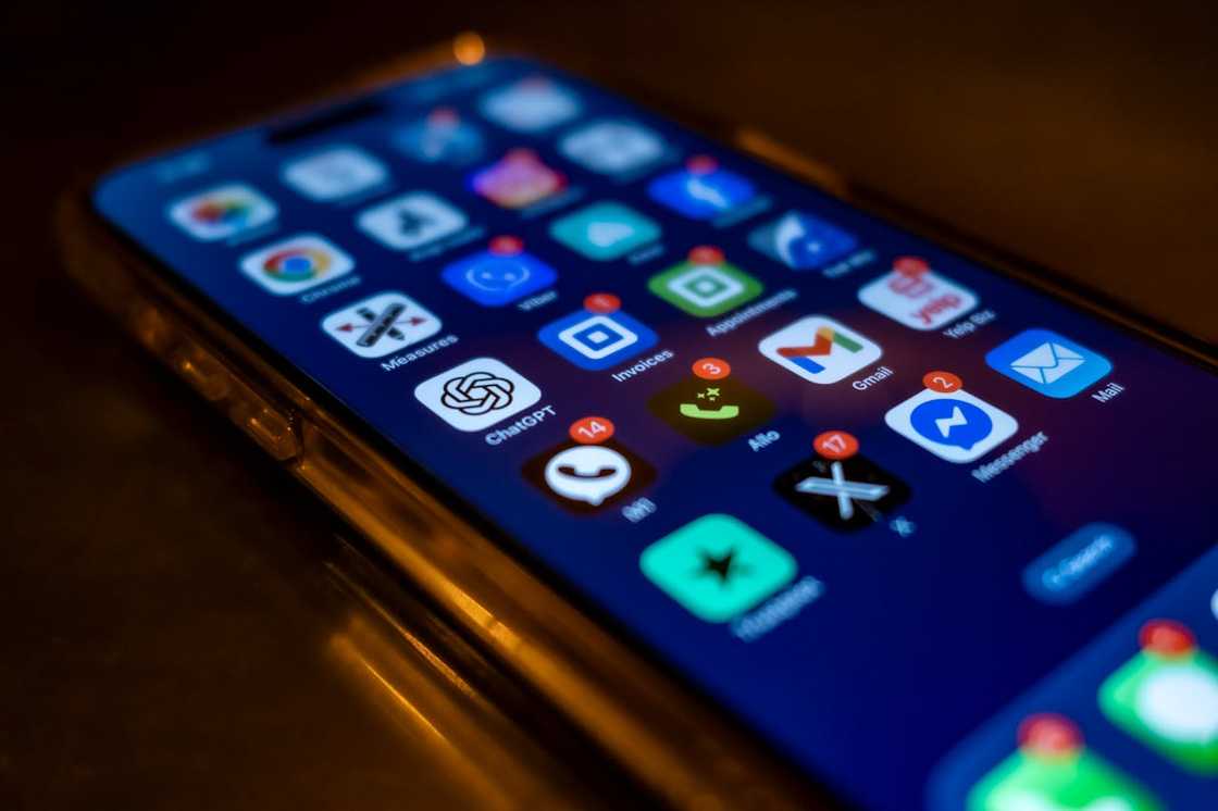 A smartphone screen showing multiple app icons in low light.