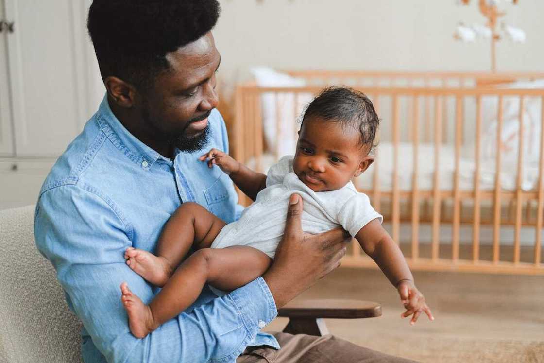 A father holds his kid with one hand