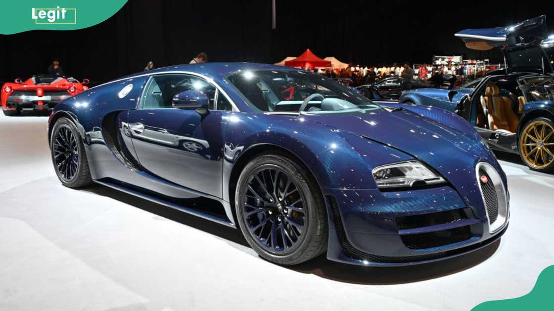 A blue 2012 Bugatti Veyron 16.4 Super Sport Hypercar is displayed in the Supercar Avenue Adrenaline Zone exhibition