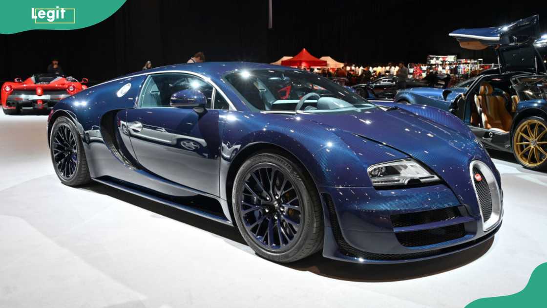 A blue 2012 Bugatti Veyron 16.4 Super Sport Hypercar is displayed in the Supercar Avenue Adrenaline Zone exhibition A blue 2012 Bugatti Veyron 16.4 Super Sport Hypercar is displayed in the Supercar Avenue Adrenaline Zone exhibition