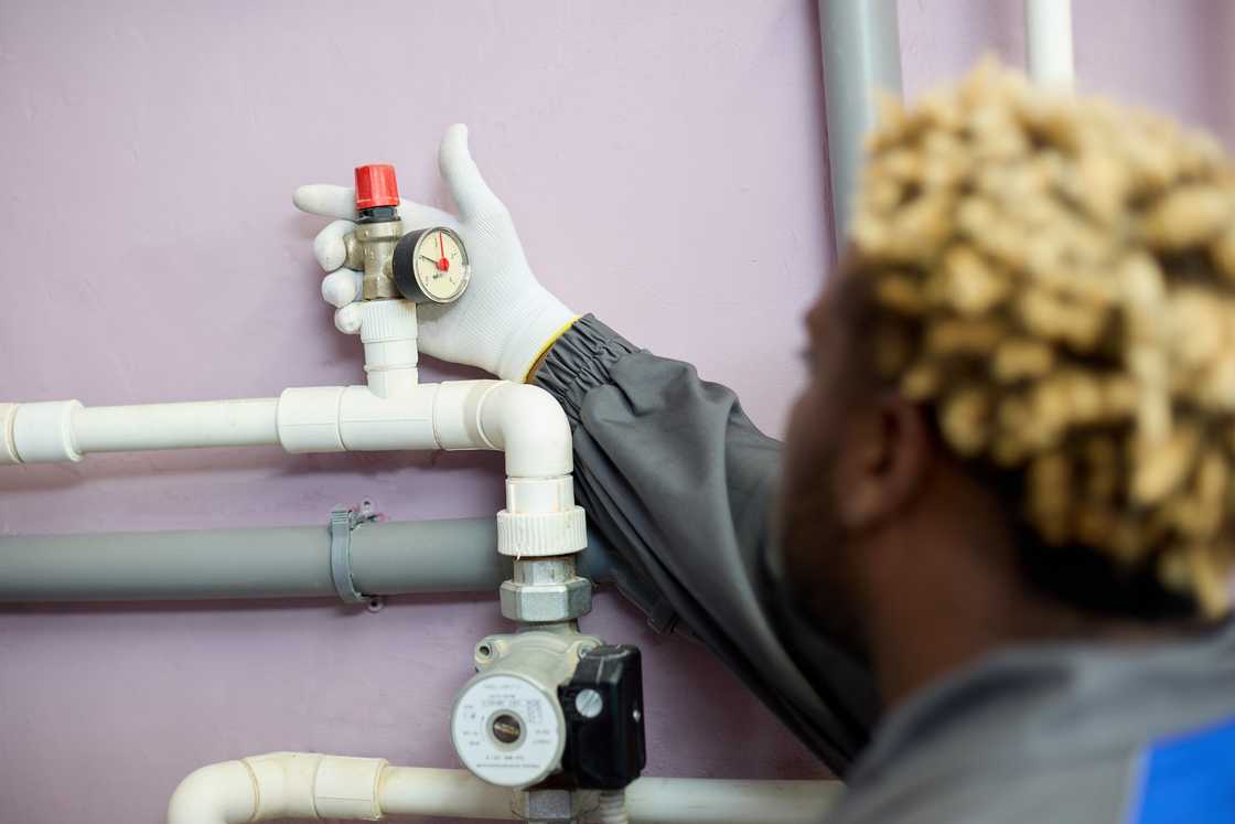 A man inspecting a water system A man inspecting a water system