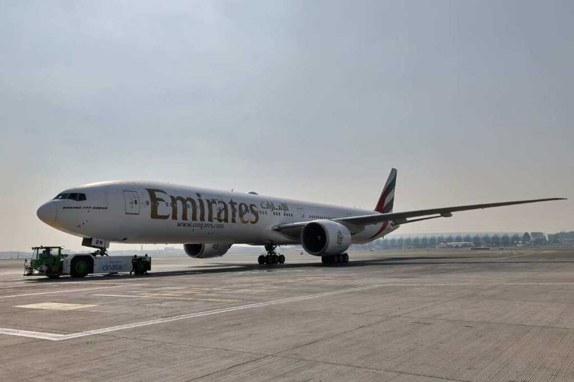 Ground crews prepare an Emirates Boeing 777-300ER aircraft, powering one of its engines with a hundred per cent Sustainable Aviation Fuel (SAF), for a demonstration flight at the Dubai International Airport in Dubai, on January 30, 2023. Emirates said it successfully flew a Boeing 777 powered by sustainable aviation fuel today, as the Middle East's largest airline aims to halve its jet fuel consumption. The Dubai-based carrier has used sustainable aviation fuel (SAF) since 2017, but said its test flight was "the first in the Middle East and North Africa to be powered by 100 percent SAF" in one of the plane's two engines. Ground crews prepare an Emirates Boeing 777-300ER aircraft, powering one of its engines with a hundred per cent Sustainable Aviation Fuel (SAF), for a demonstration flight at the Dubai International Airport in Dubai, on January 30, 2023. Emirates said it successfully flew a Boeing 777 powered by sustainable aviation fuel today, as the Middle East's largest airline aims to halve its jet fuel consumption. The Dubai-based carrier has used sustainable aviation fuel (SAF) since 2017, but said its test flight was "the first in the Middle East and North Africa to be powered by 100 percent SAF" in one of the plane's two engines.