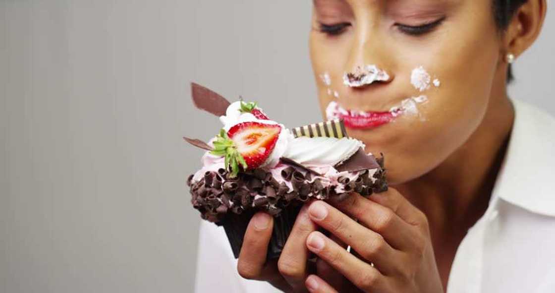 woman eats cupcake woman eats cupcake