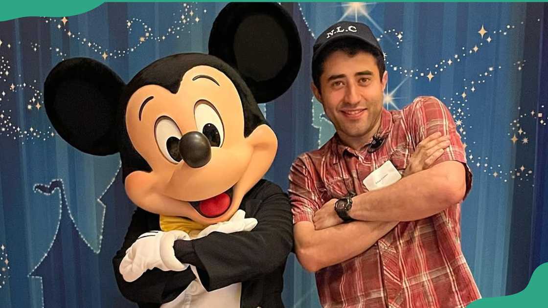 Adan Correa poses next to a Mickey Mouse dummy Adan Correa poses next to a Mickey Mouse dummy