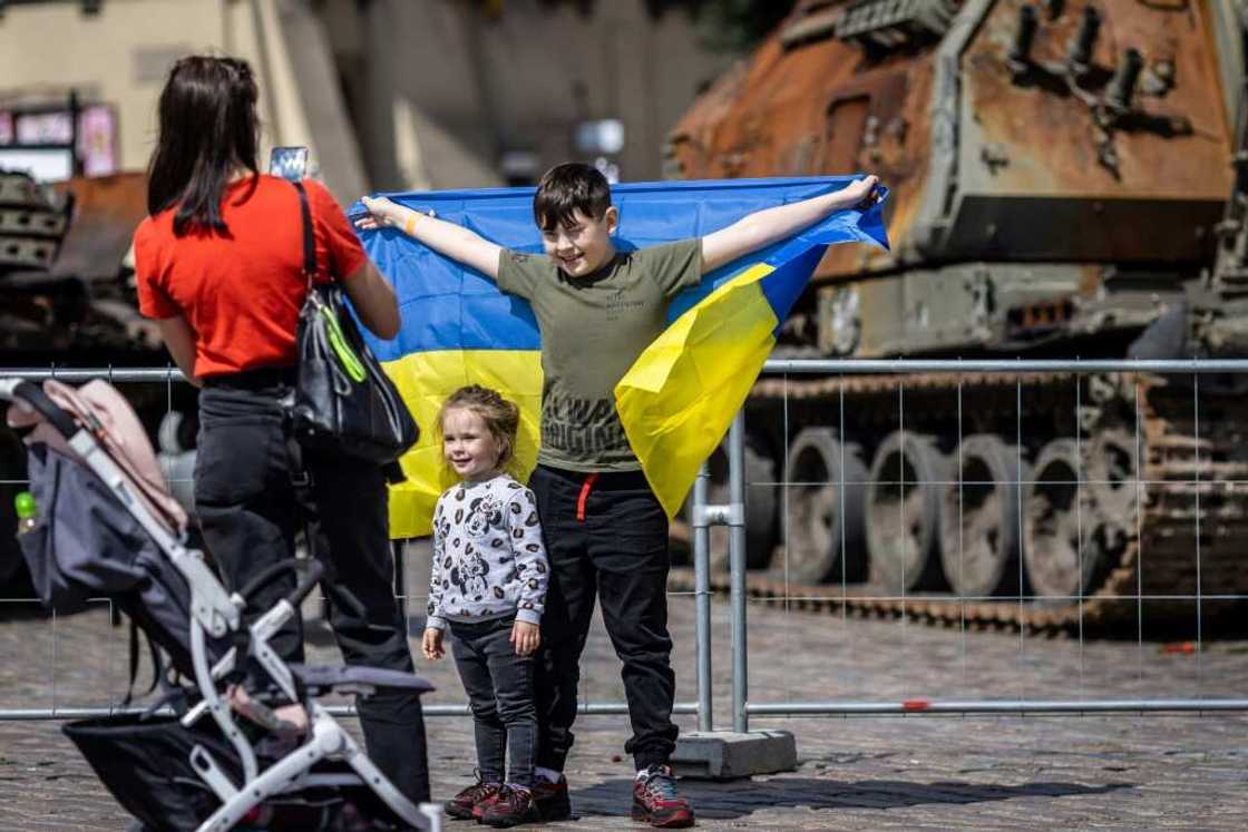Ukrainian children pose in front of the tanks. Poland has welcomed more than 4.5 million Ukrainians since the invasion Ukrainian children pose in front of the tanks. Poland has welcomed more than 4.5 million Ukrainians since the invasion