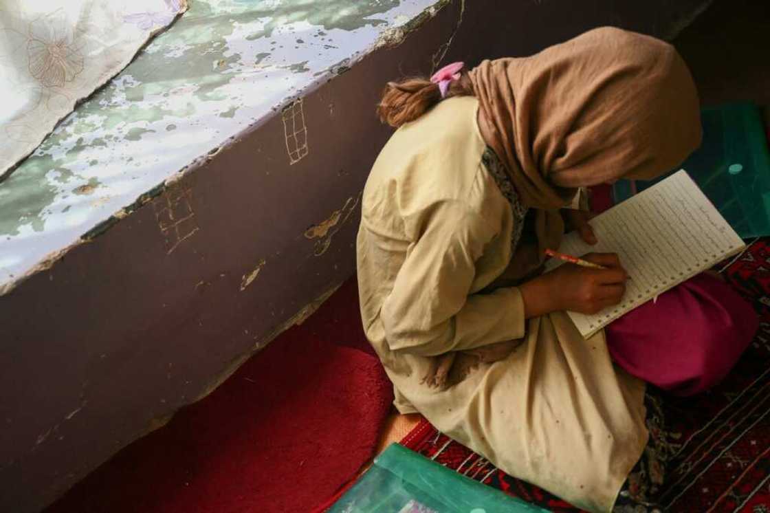 A girl studies in a secret school at an undisclosed location in Afghanistan A girl studies in a secret school at an undisclosed location in Afghanistan