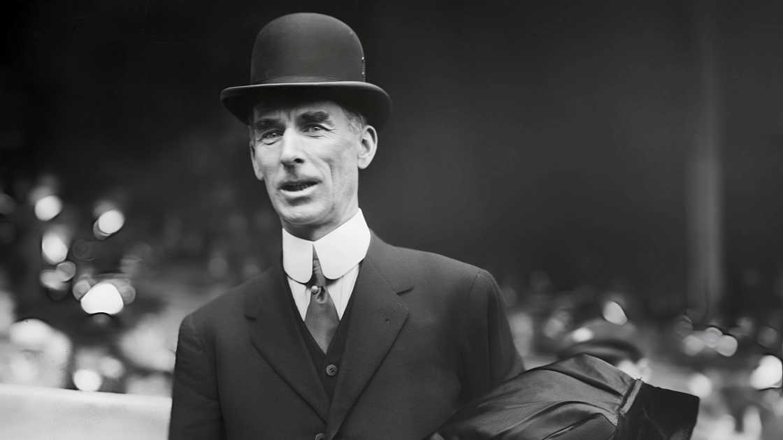 Connie Mack, Philadelphia Athletics's manager was pictured standing on a baseball field.