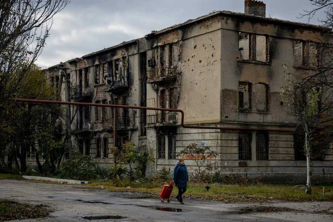 A woman walks past a damaged building in Lyman in the Donetsk region of Ukraine after the recapture of the area from Russian forces A woman walks past a damaged building in Lyman in the Donetsk region of Ukraine after the recapture of the area from Russian forces