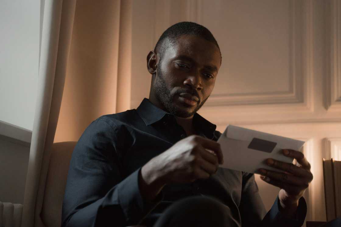 A man holding an envelope A man holding an envelope