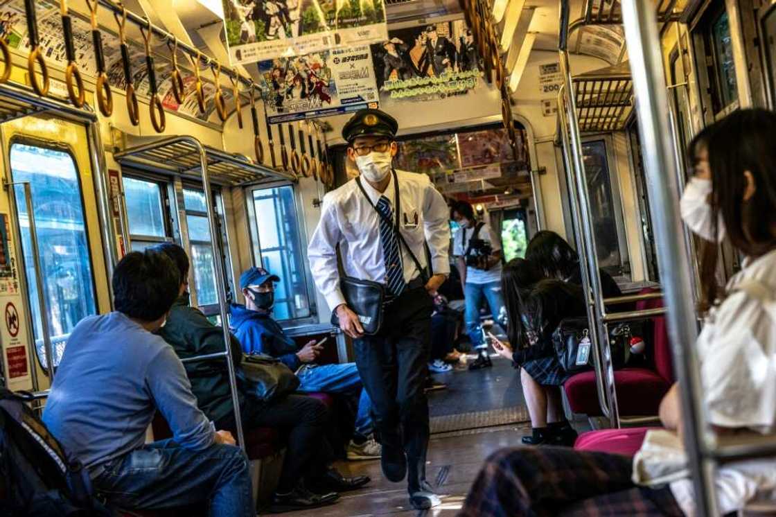 A conductor hustles through the train after checking tickets on the Choshi Electric Railway Line in northeast Chiba prefecture A conductor hustles through the train after checking tickets on the Choshi Electric Railway Line in northeast Chiba prefecture