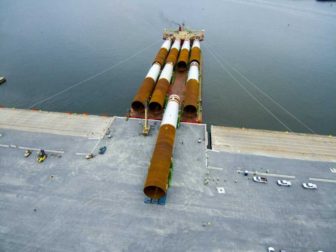 Steel monopile foundations for the Coastal Virginia Offshore Wind commercial project are offloaded at Portsmouth Marine Terminal in Portsmouth, Virginia Steel monopile foundations for the Coastal Virginia Offshore Wind commercial project are offloaded at Portsmouth Marine Terminal in Portsmouth, Virginia
