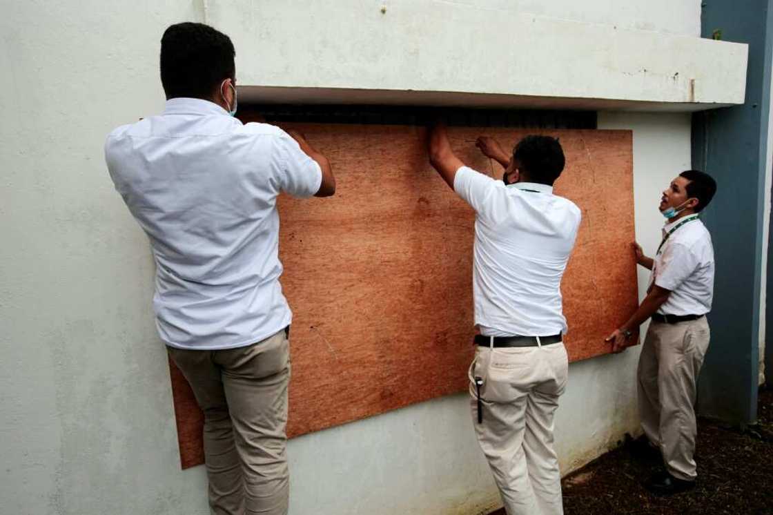 Workers protect the windows of a bank on October 8, 2022 before the arrival of Hurricane Julia in Bluefields, Nicaragua Workers protect the windows of a bank on October 8, 2022 before the arrival of Hurricane Julia in Bluefields, Nicaragua