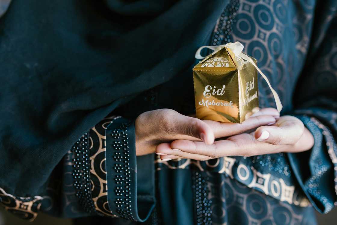 A lady holding an Eid present A lady holding an Eid present