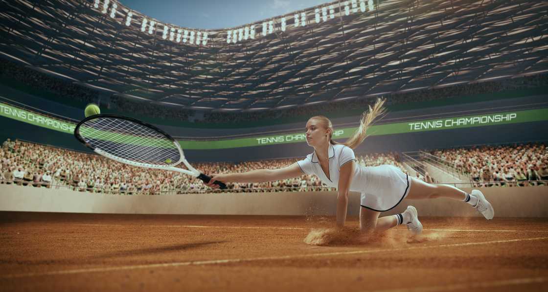 A Woman tennis player playing tennis in a professional tennis stadium