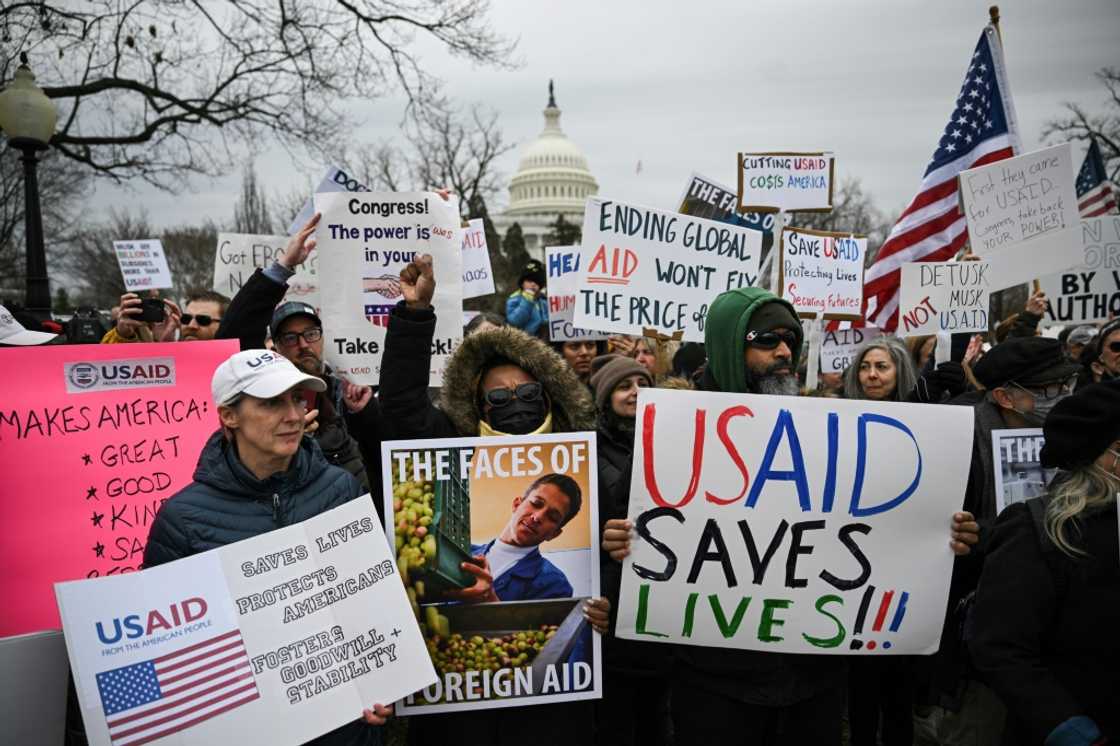 People protest in Washington against President Donald Trump's administration's efforts to shutter the US Agency for International Development and lay off thousands of federal employees