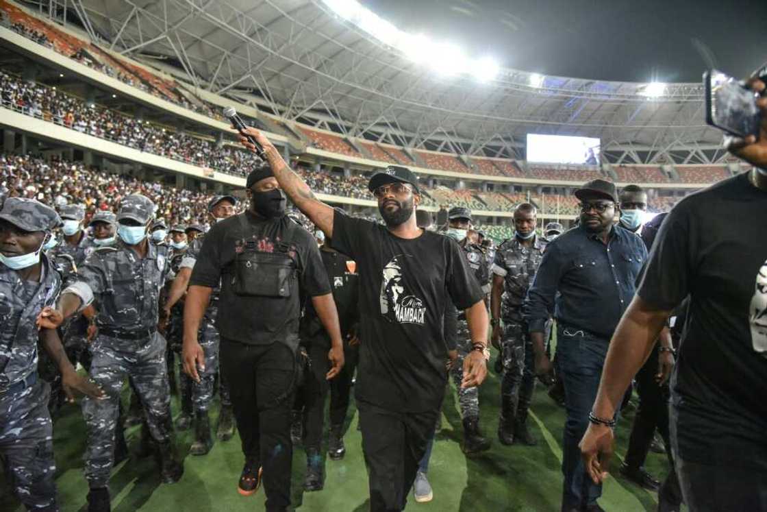 Fally Ipupa has a police escort leaving Abidjan's Olympic stadium in March last year Fally Ipupa has a police escort leaving Abidjan's Olympic stadium in March last year