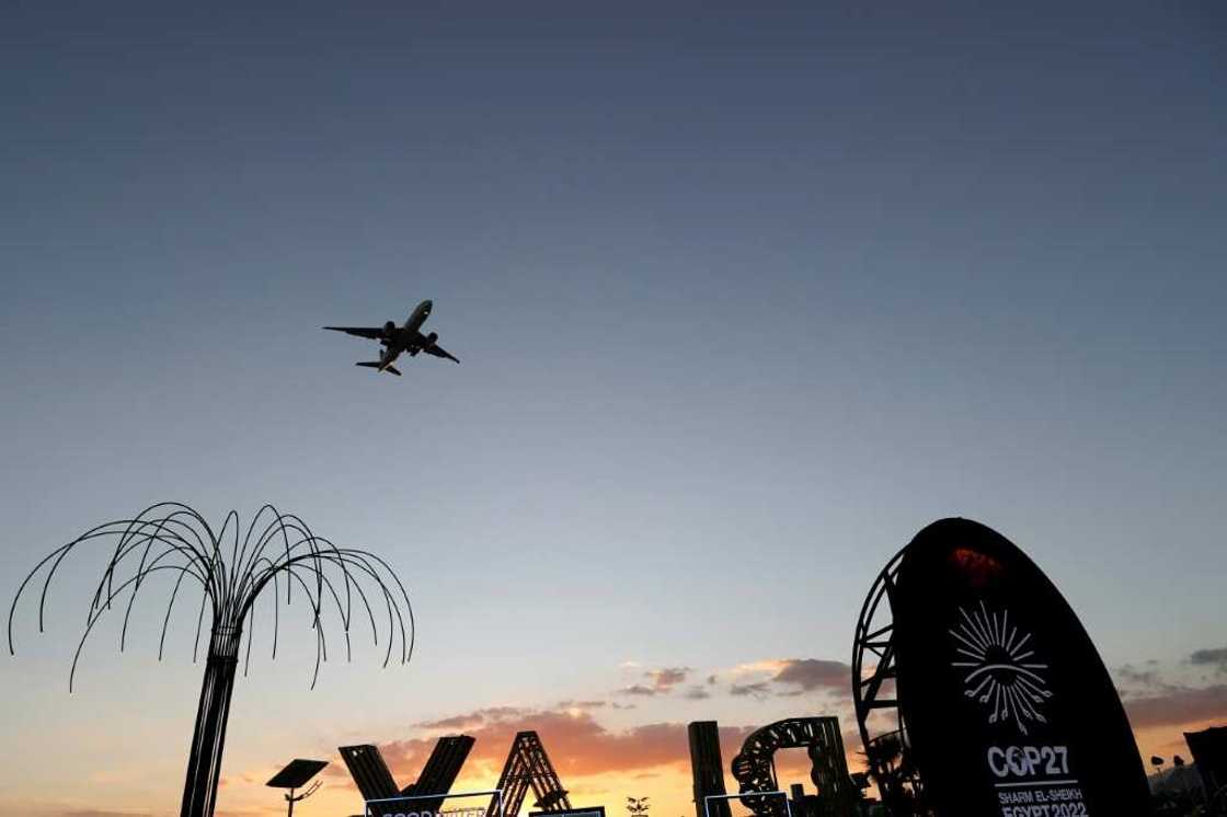An aeroplane flies above the green zone at the Sharm el-Sheikh International Convention Centre, during the COP27 climate conference An aeroplane flies above the green zone at the Sharm el-Sheikh International Convention Centre, during the COP27 climate conference
