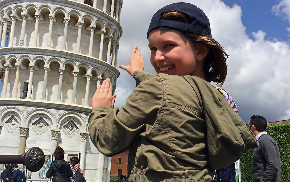Addison gestures while visiting the Leaning Tower of Pisa