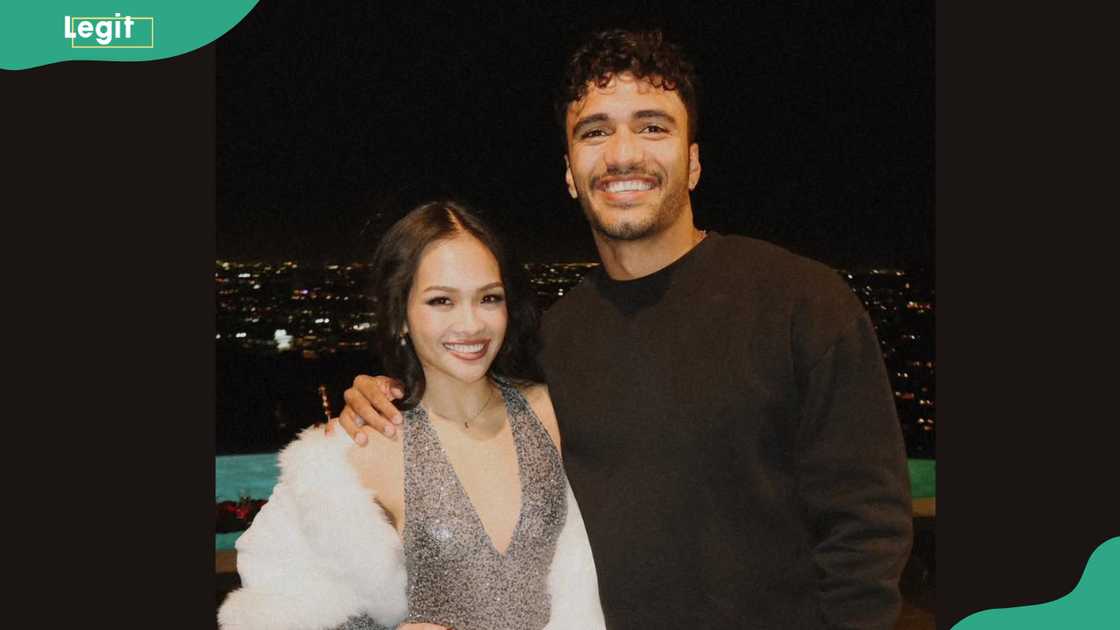 Jenn Tran and Jonathan posing together at night Jenn Tran and Jonathan posing together at night