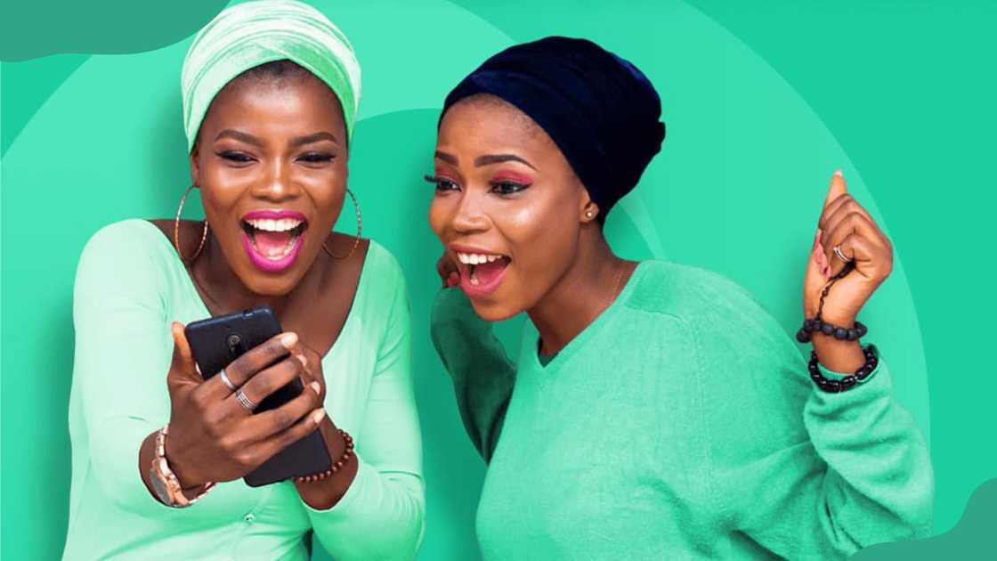 Two young women looking at a phone.