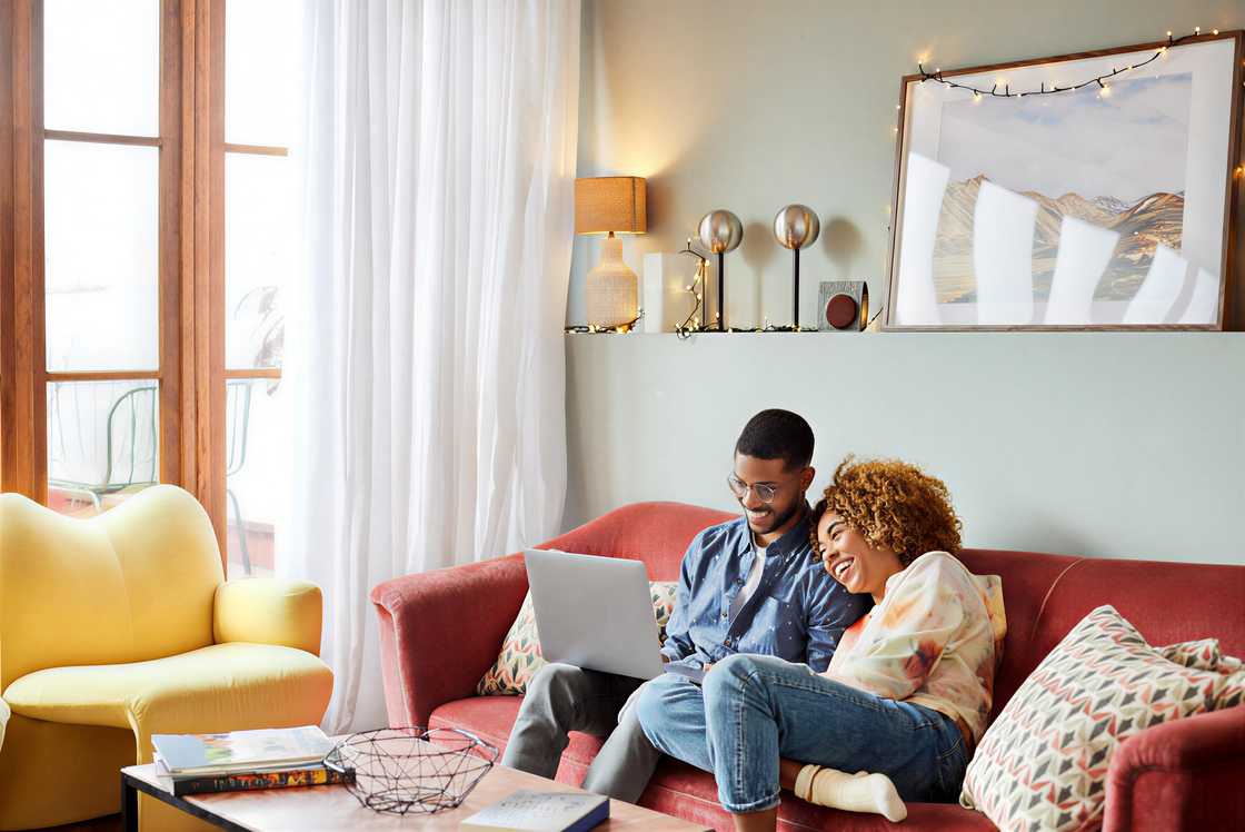 An African woman is leaning on a man