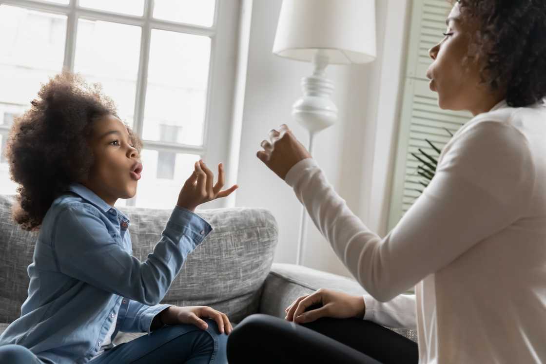 A mother and daughter using sign language