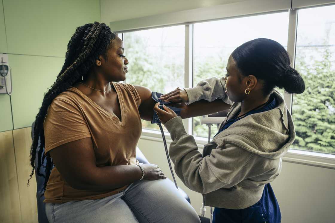 A lady getting her pressure checked A lady getting her pressure checked