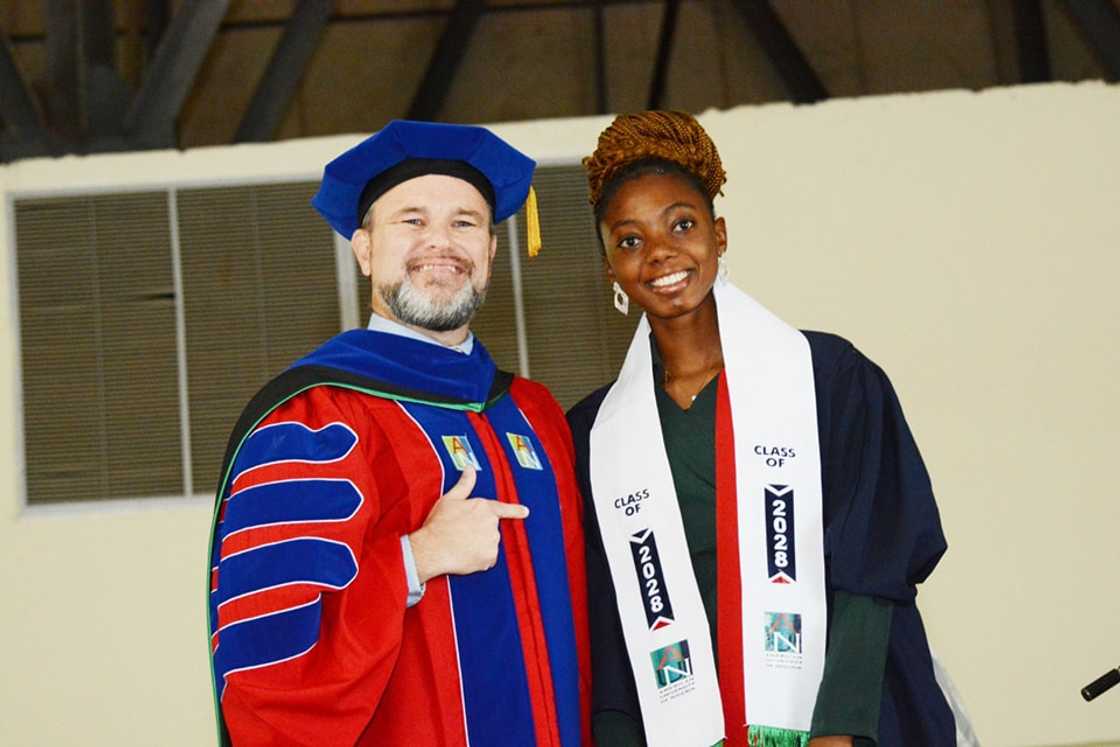American University of Nigeria Vice Chancellor and student posing for a photo on graduation day American University of Nigeria Vice Chancellor and student posing for a photo on graduation day
