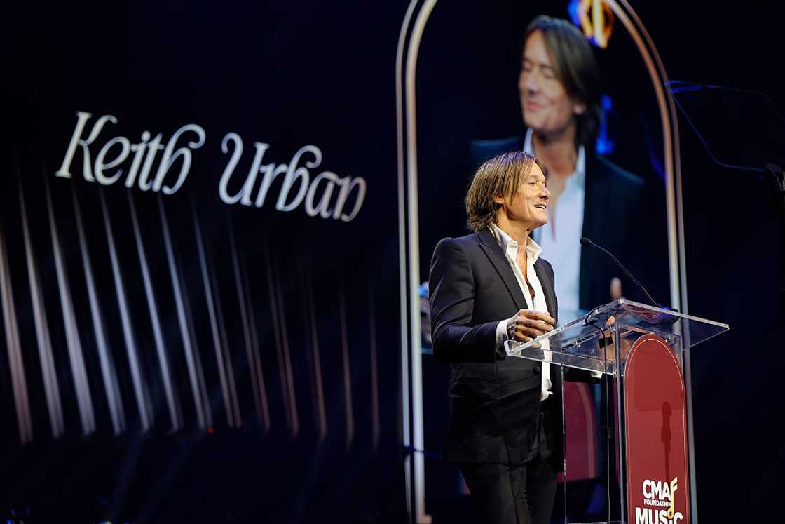 Keith Urban on stage delivering a speech