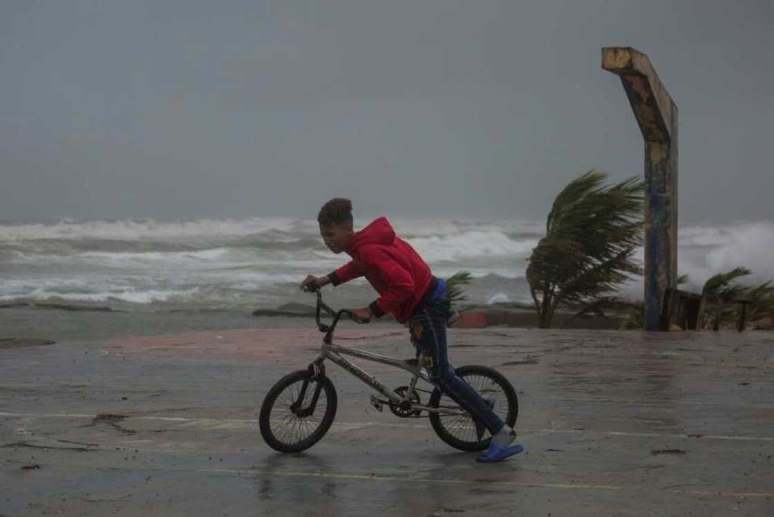 A young person rides his bicycle in Nagua, Dominican Republic A young person rides his bicycle in Nagua, Dominican Republic