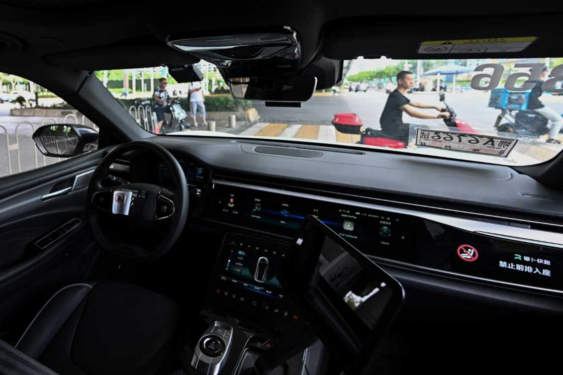 A view from the back seat of a driverless taxi as it navigates through Wuhan, now home to more than 500 so called "robotaxis"