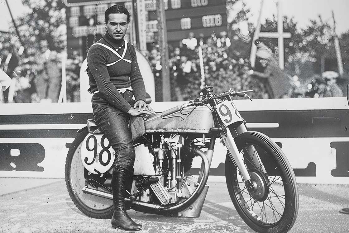 Piero Taruffi is pictured sitting on his Norton 500 motorcycle. Piero Taruffi is pictured sitting on his Norton 500 motorcycle.