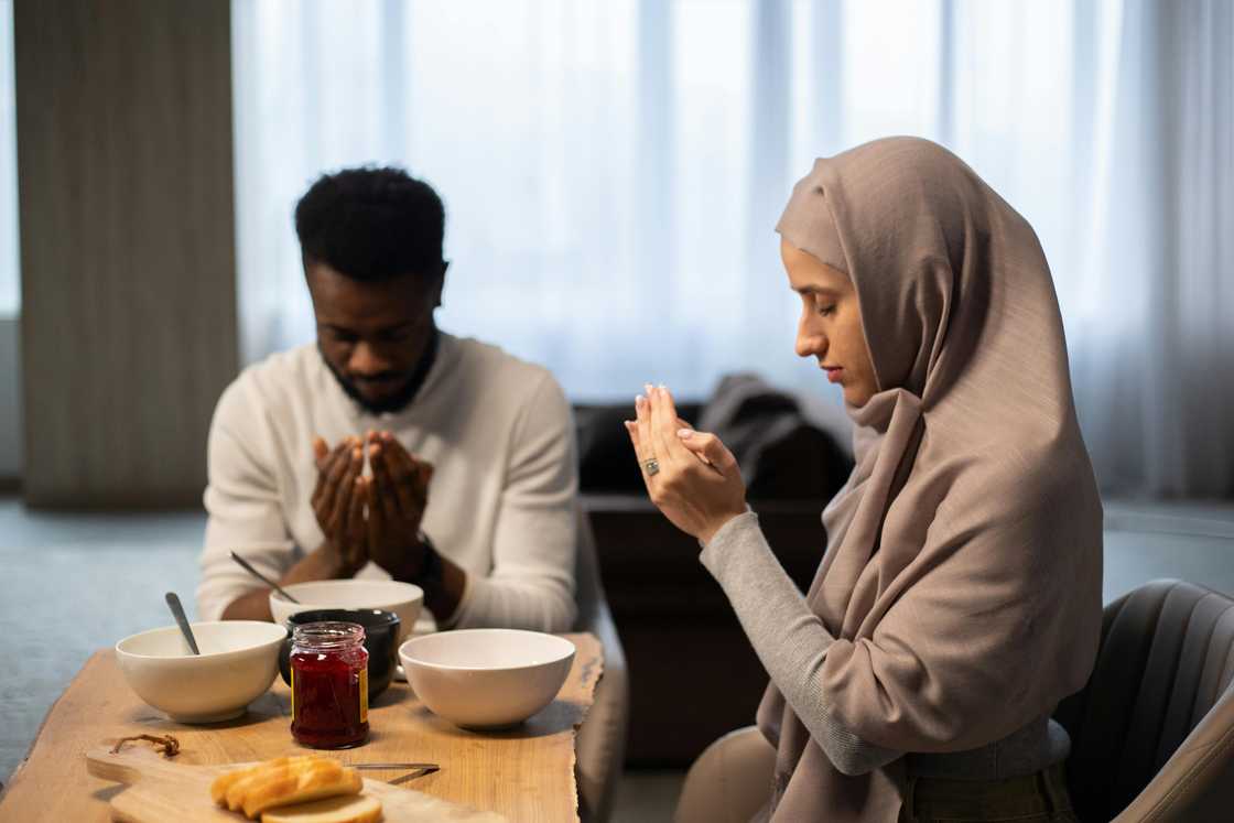 A Muslim multiethnic couple is praying