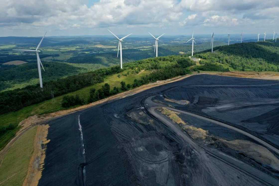 A wind farm overlooks a coal-treatment facility in Oakland, Maryland A wind farm overlooks a coal-treatment facility in Oakland, Maryland