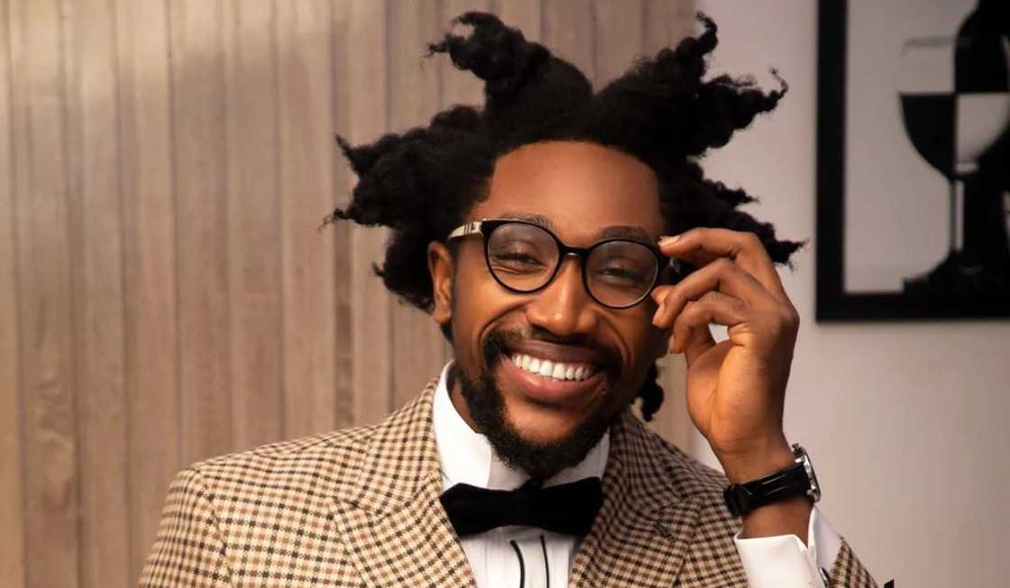 Cassi from BBNaija holds his glasses in a pose Cassi from BBNaija holds his glasses in a pose