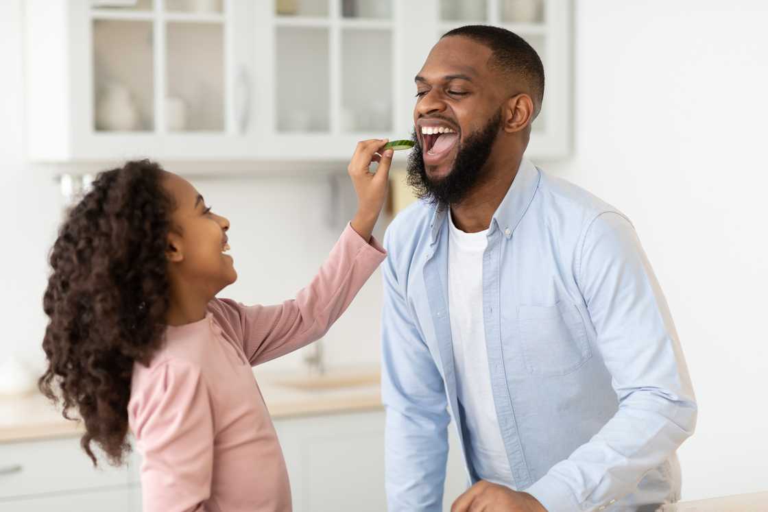 Father and daughter bond playfully. Father and daughter bond playfully.