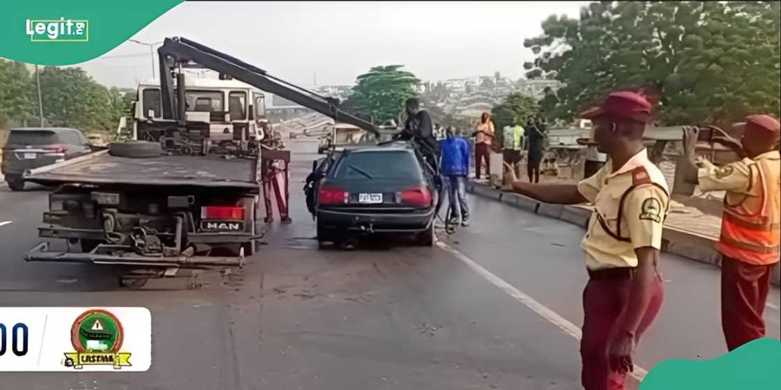 LASTMA officials and residents during rescue operations at the crash scene near Meiran Primary Health Centre. LASTMA officials and residents during rescue operations at the crash scene near Meiran Primary Health Centre.