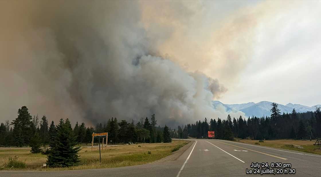 In this July 2024 image, smoke rises from a wildfire burning in Jasper National Park in Canada. The wildfire devoured up to half of the main town