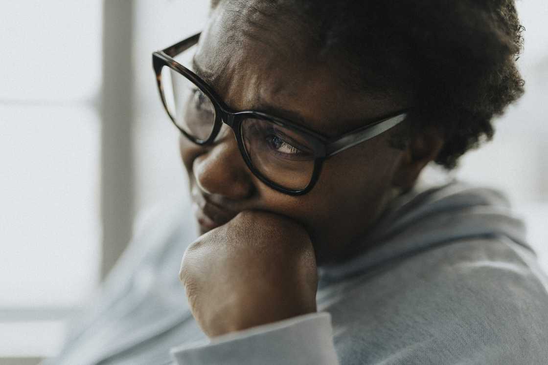 A distressed woman staring in a hospital.